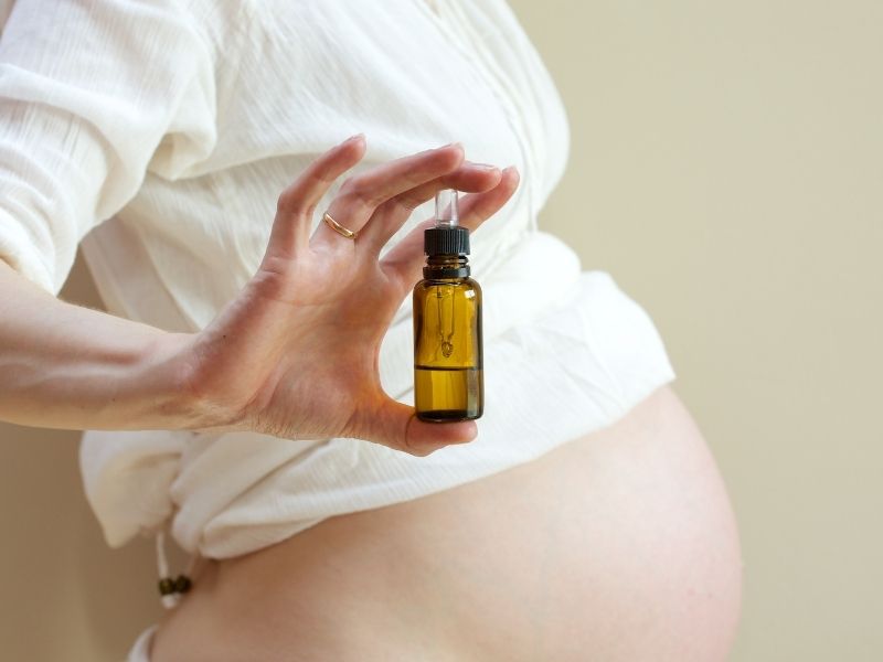pregnant woman with essential oil