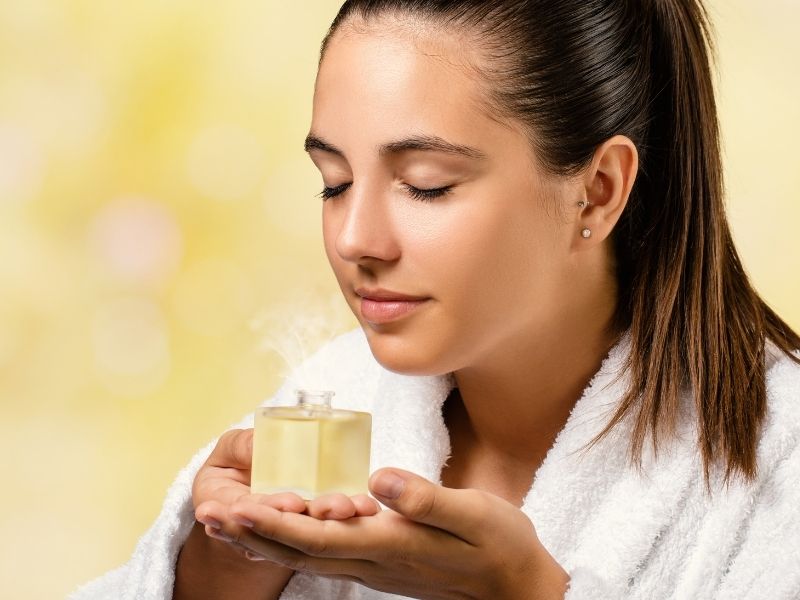 woman smelling essential oils